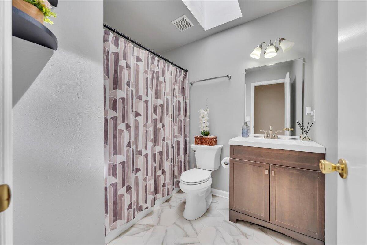 4751 Westvale Road Northeast Roanoke, VA 24019 - Photo 18 of 30 a bathroom with a sink a toilet and shower