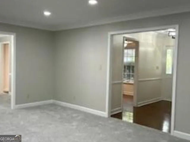 a view of walk in closet with empty racks