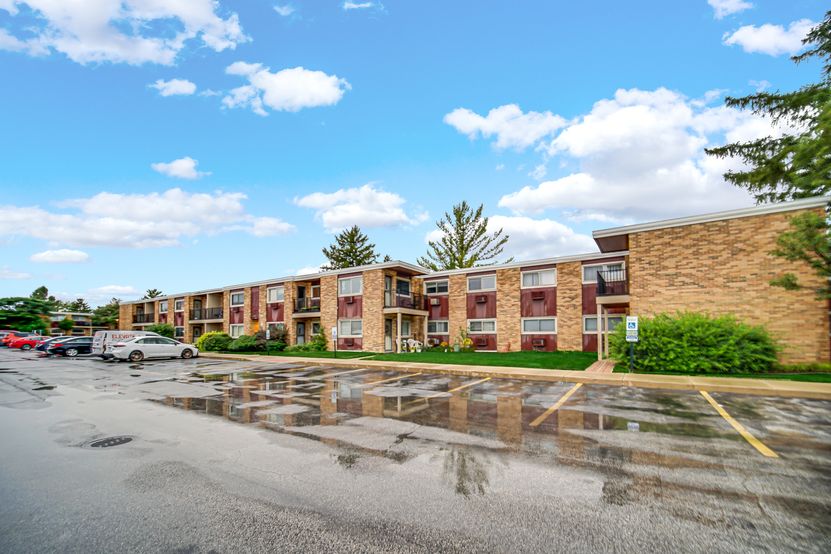 1320 Lore Lane, Unit 107B Lombard, IL 60148 - Photo 15 of 48 a view of a blue house with a yard