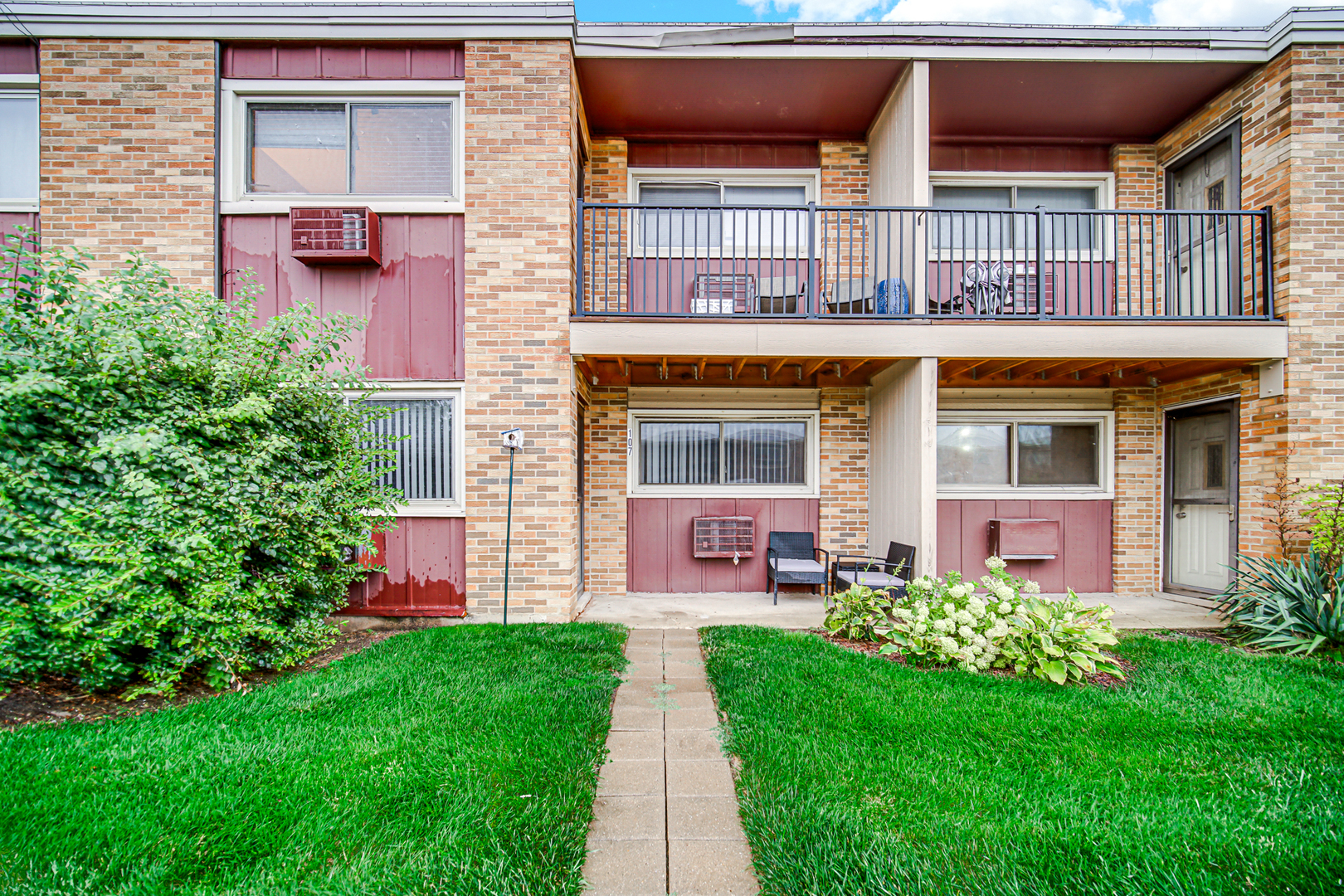 1320 Lore Lane, Unit 107B Lombard, IL 60148 - Photo 16 of 48 a front view of a house with a yard