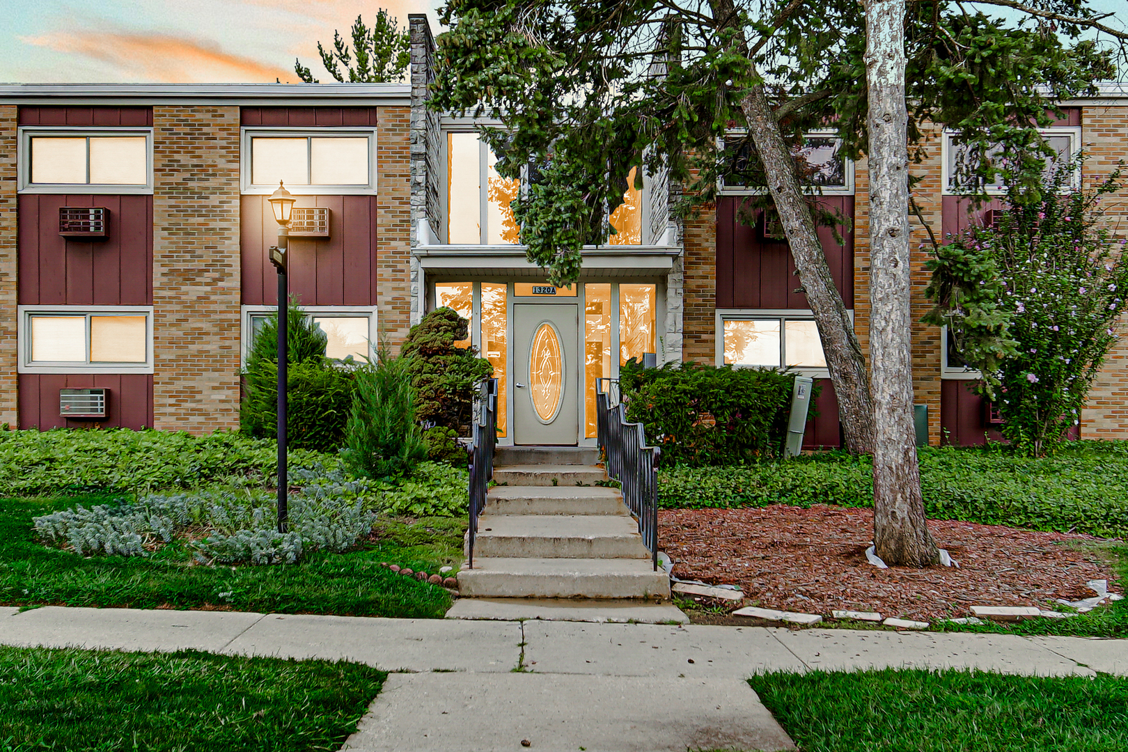 1320 Lore Lane, Unit 107B Lombard, IL 60148 - Photo 26 of 48 a front view of a house with a yard and trees