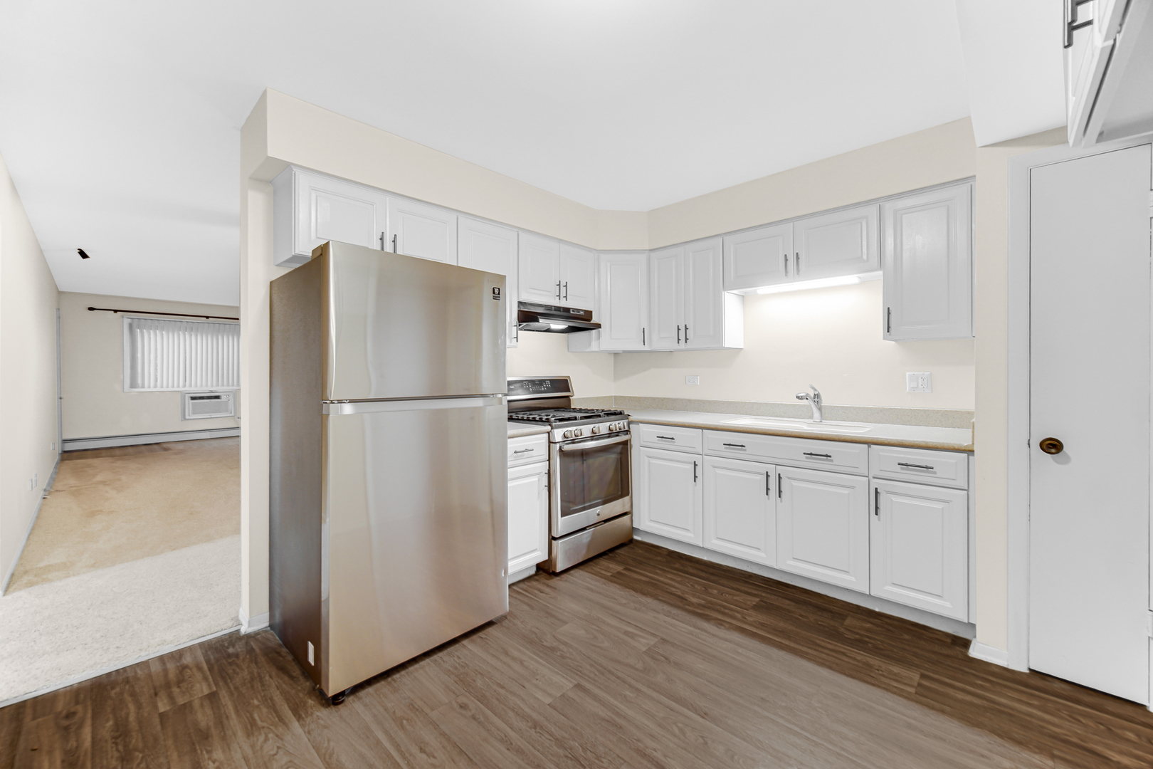 1320 Lore Lane, Unit 107B Lombard, IL 60148 - Photo 27 of 48 a kitchen with a refrigerator stove and wooden cabinets