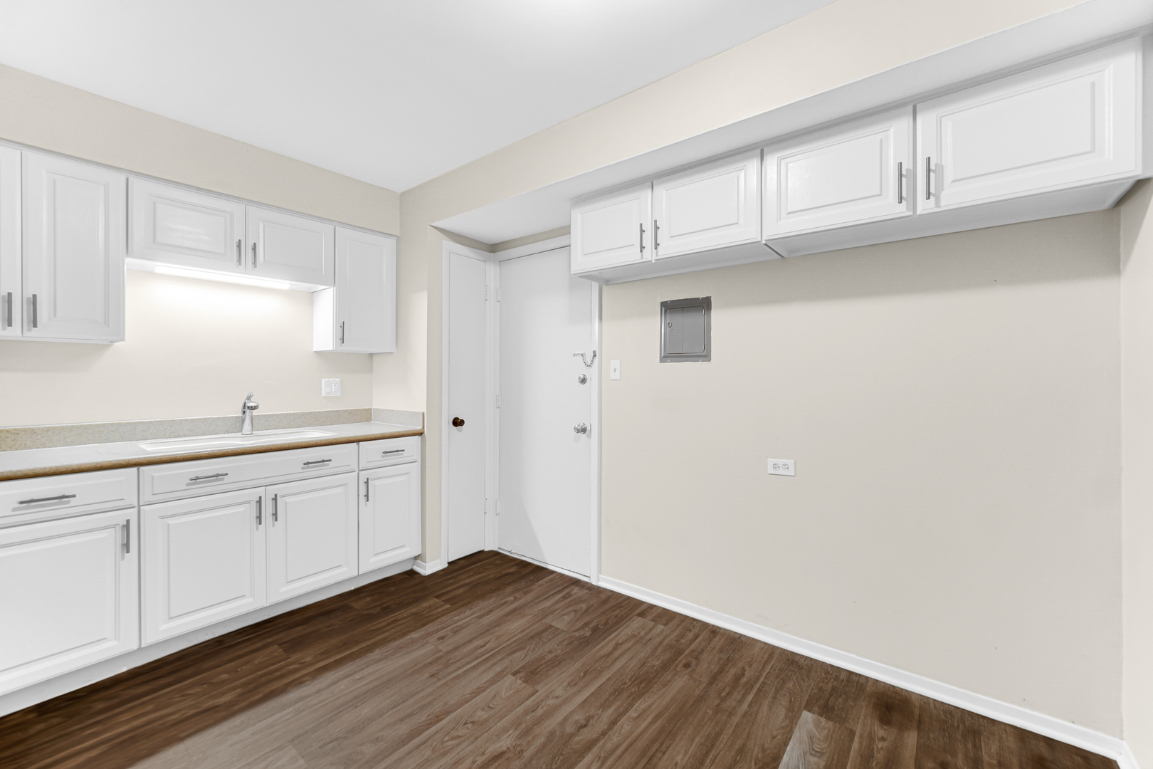 1320 Lore Lane, Unit 107B Lombard, IL 60148 - Photo 28 of 48 a kitchen with granite countertop white cabinets and wooden floor