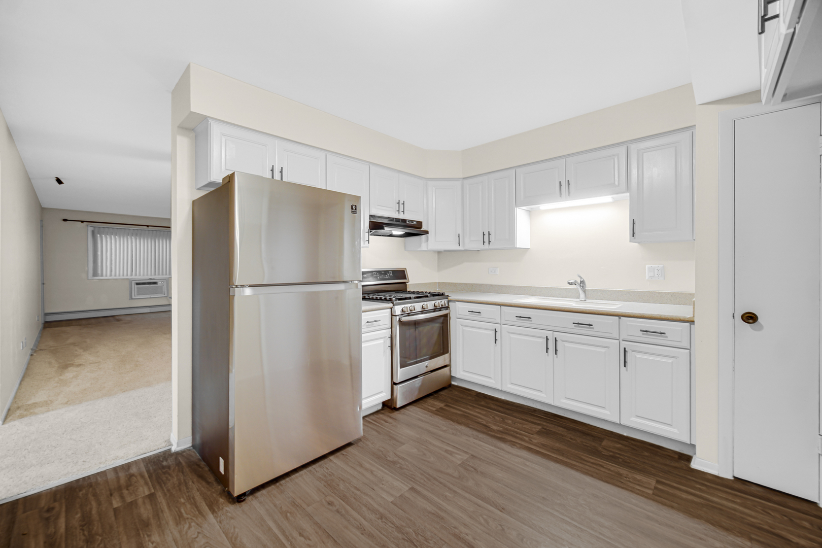 1320 Lore Lane, Unit 107B Lombard, IL 60148 - Photo 3 of 48 a kitchen with a refrigerator stove and wooden cabinets