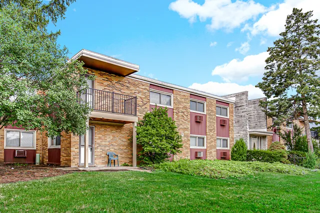 a front view of a building with a garden