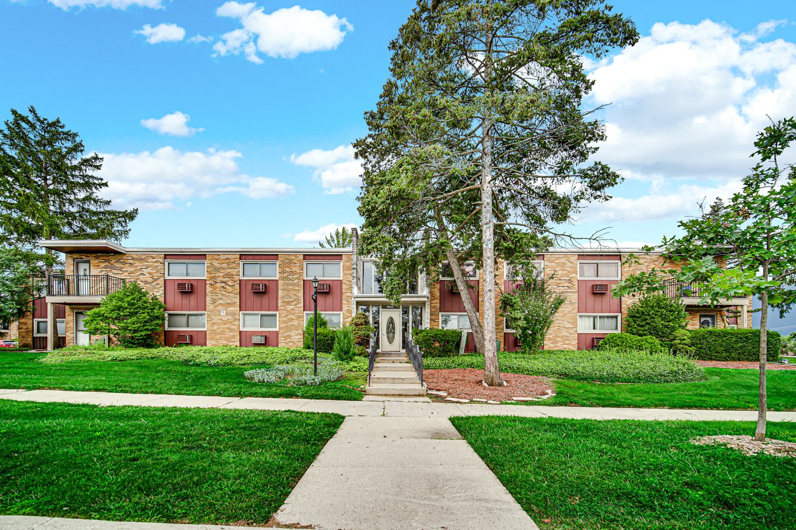 1320 Lore Lane, Unit 107B Lombard, IL 60148 - Photo 43 of 48 a front view of a building with garden