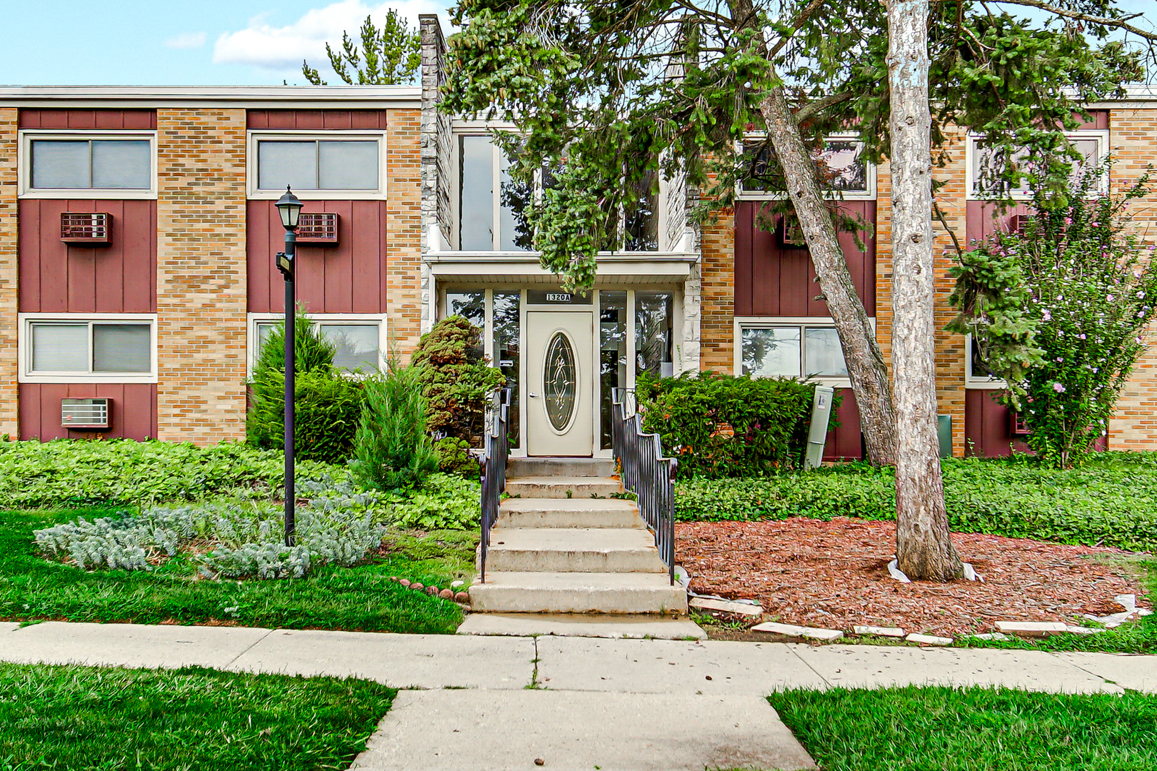 1320 Lore Lane, Unit 107B Lombard, IL 60148 - Photo 45 of 48 a front view of a house with yard and green space