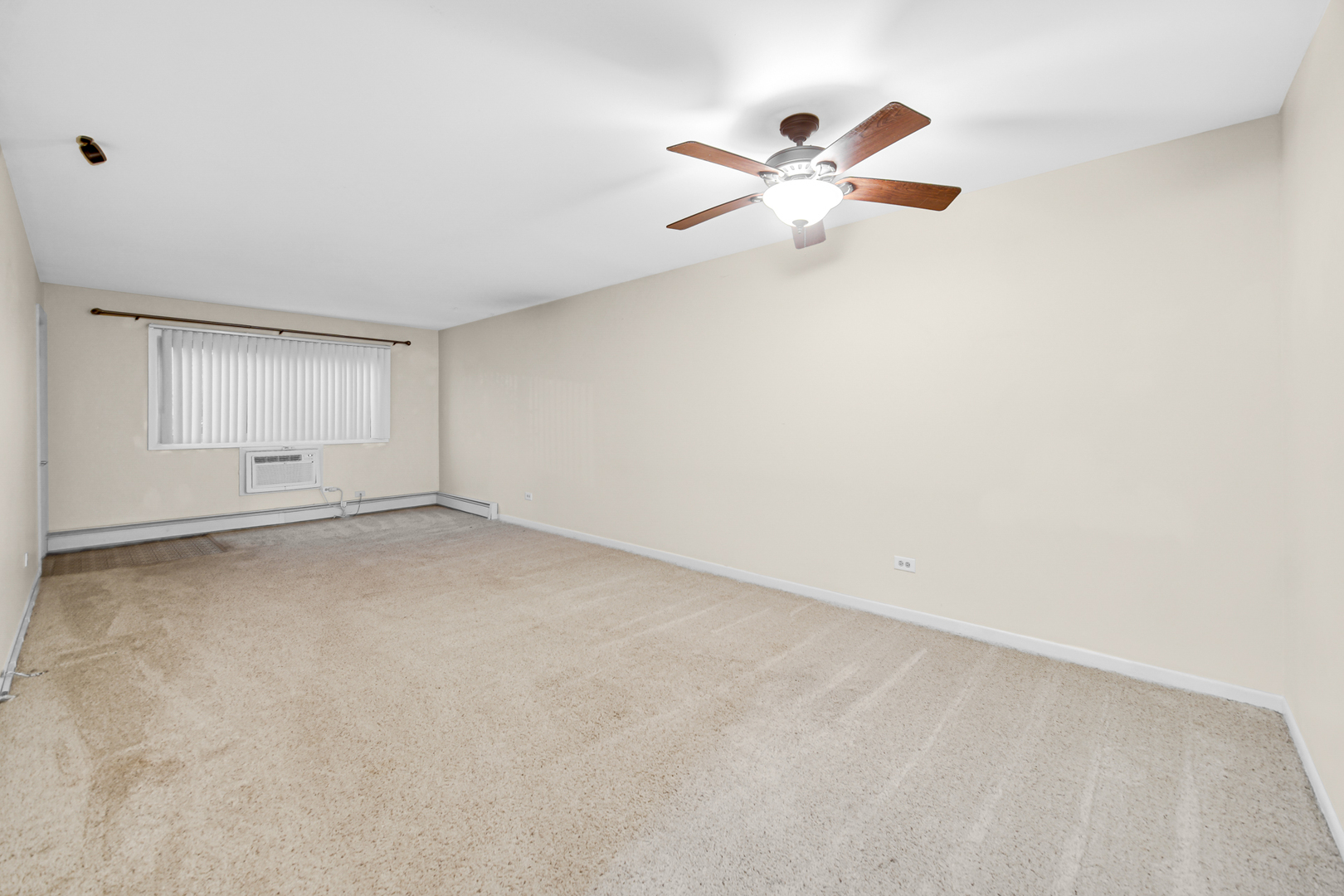 1320 Lore Lane, Unit 107B Lombard, IL 60148 - Photo 7 of 48 an empty room with windows and fan