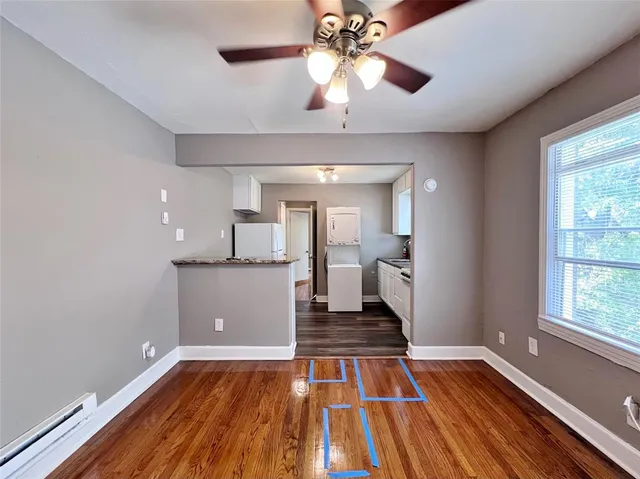 a view of a room with wooden floor and staircase
