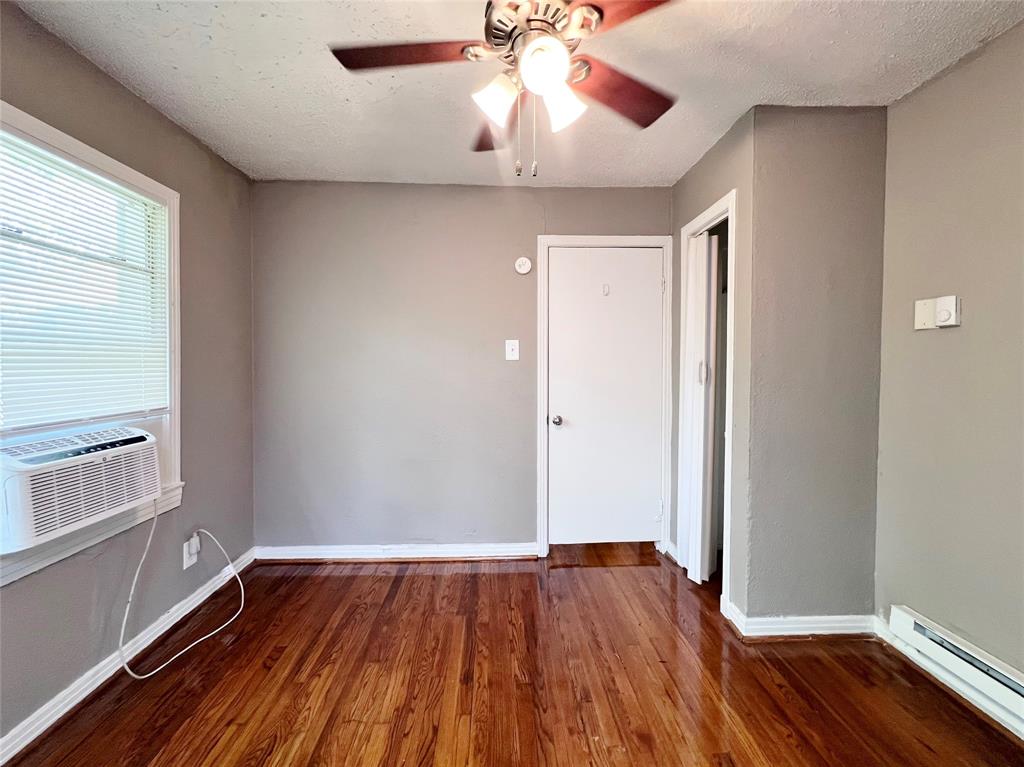 1121 North Bishop Avenue, Unit C Dallas, TX 75208 - Photo 9 of 11 wooden floor in an empty room with a window