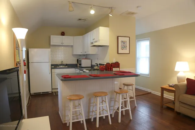 a kitchen that has a table and chairs in it