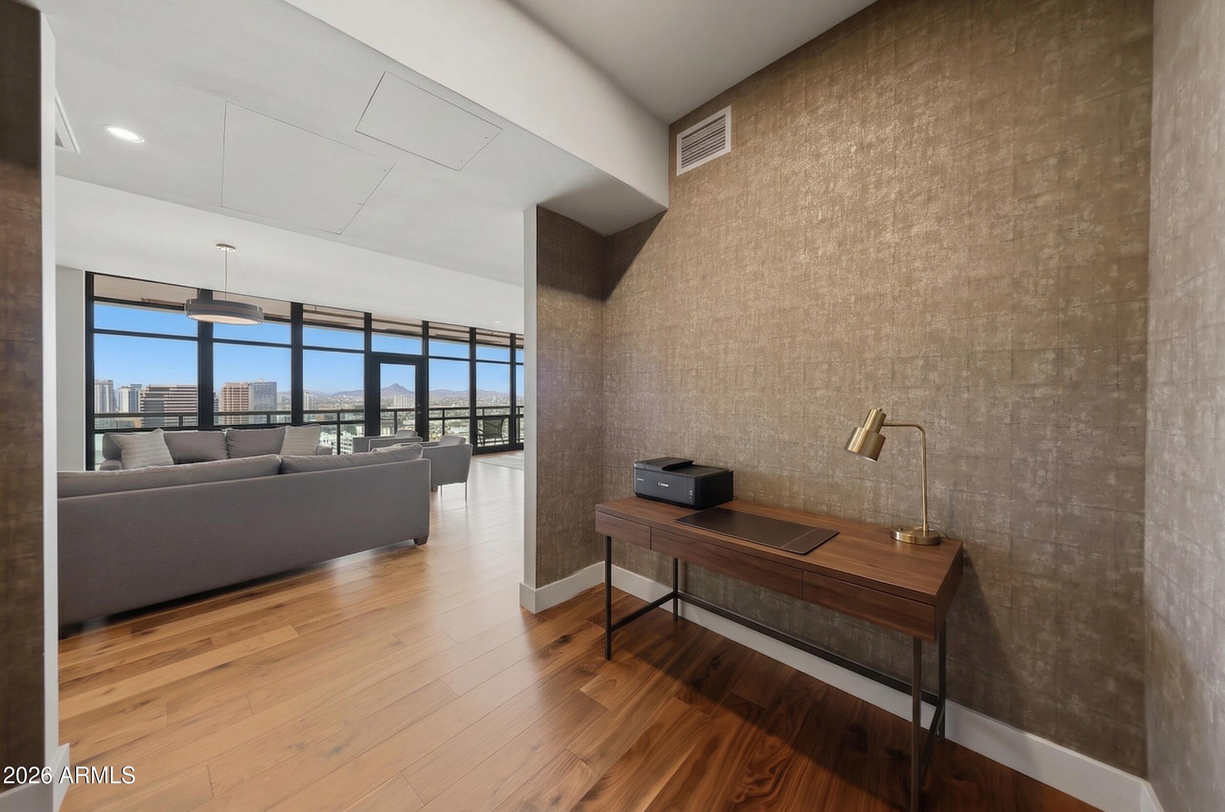 310 South 4th Street, Unit 2204 Phoenix, AZ 85004 - Photo 13 of 66 a reading room with wooden floor and furniture
