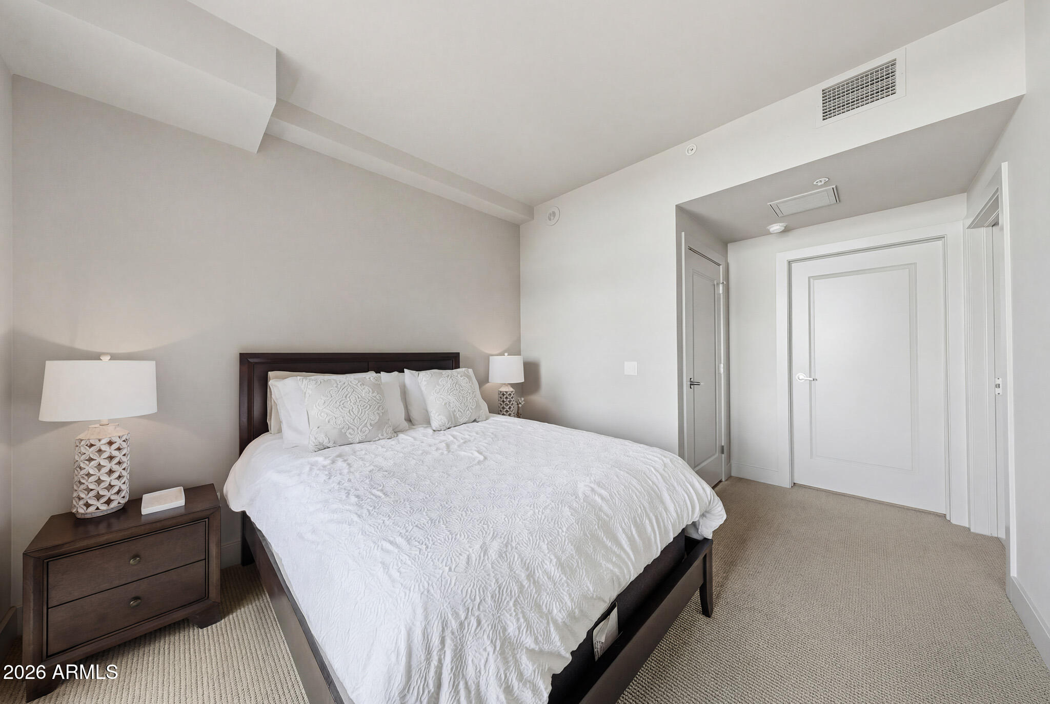 310 South 4th Street, Unit 2204 Phoenix, AZ 85004 - Photo 39 of 66 a bedroom with a bed and a night stand