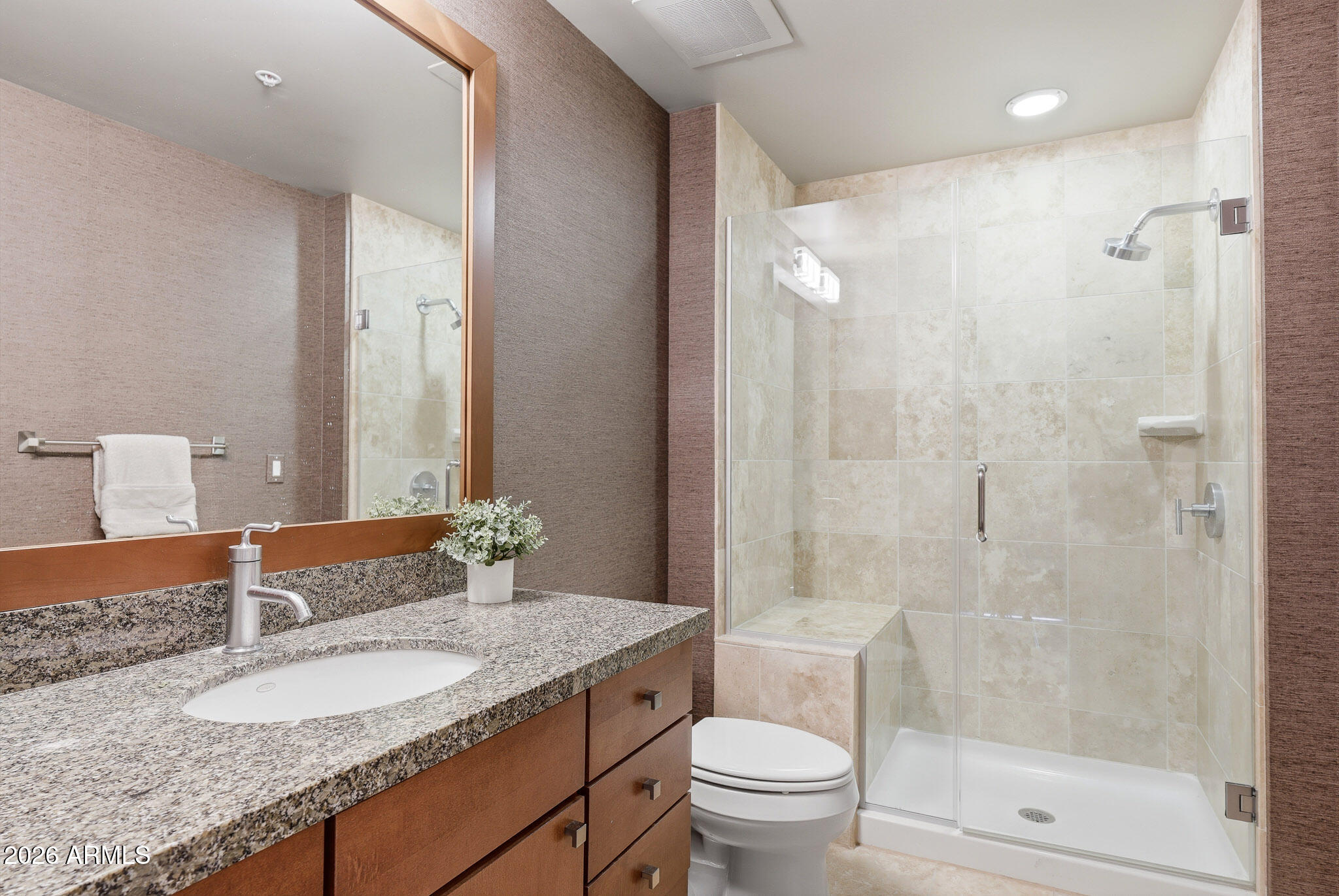 310 South 4th Street, Unit 2204 Phoenix, AZ 85004 - Photo 40 of 66 a bathroom with a granite countertop sink a toilet a mirror and shower