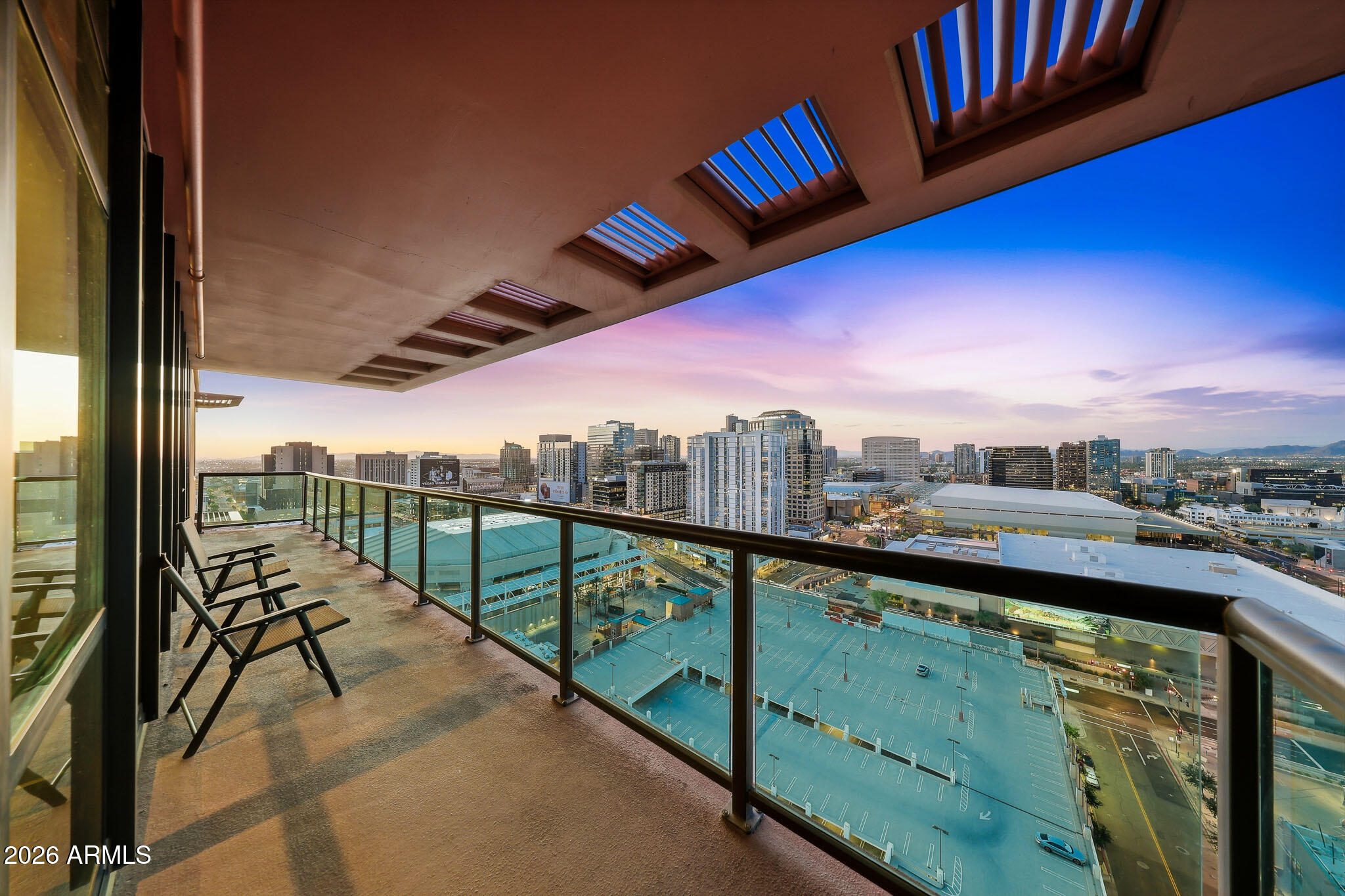 310 South 4th Street, Unit 2204 Phoenix, AZ 85004 - Photo 62 of 66 a view of a city from a balcony with furniture
