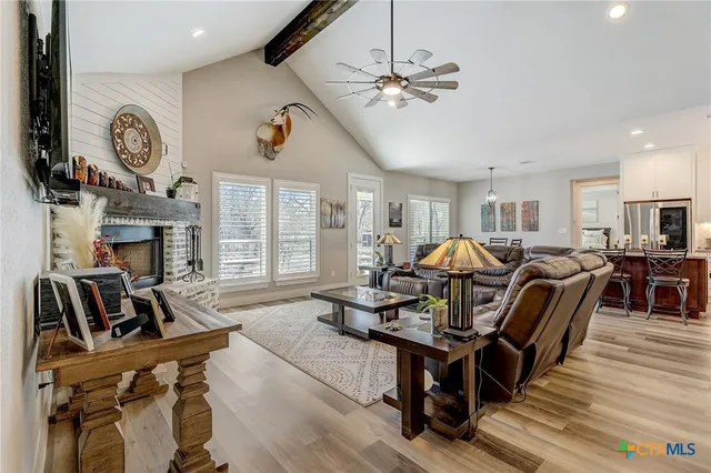 a living room with lots of furniture and kitchen view