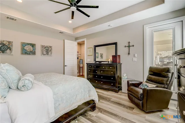 a large bedroom with a bed and a dresser