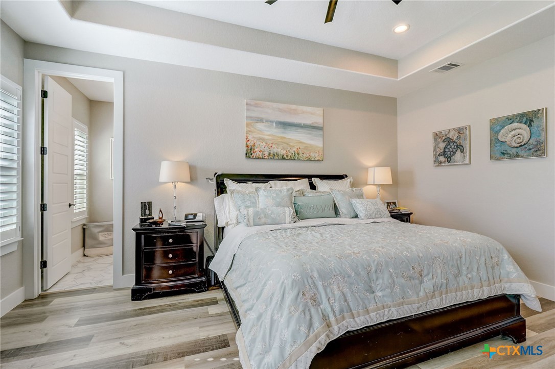 281 Cibolo Way La Vernia, TX 78121 - Photo 18 of 47 a bedroom with a bed and wooden floor