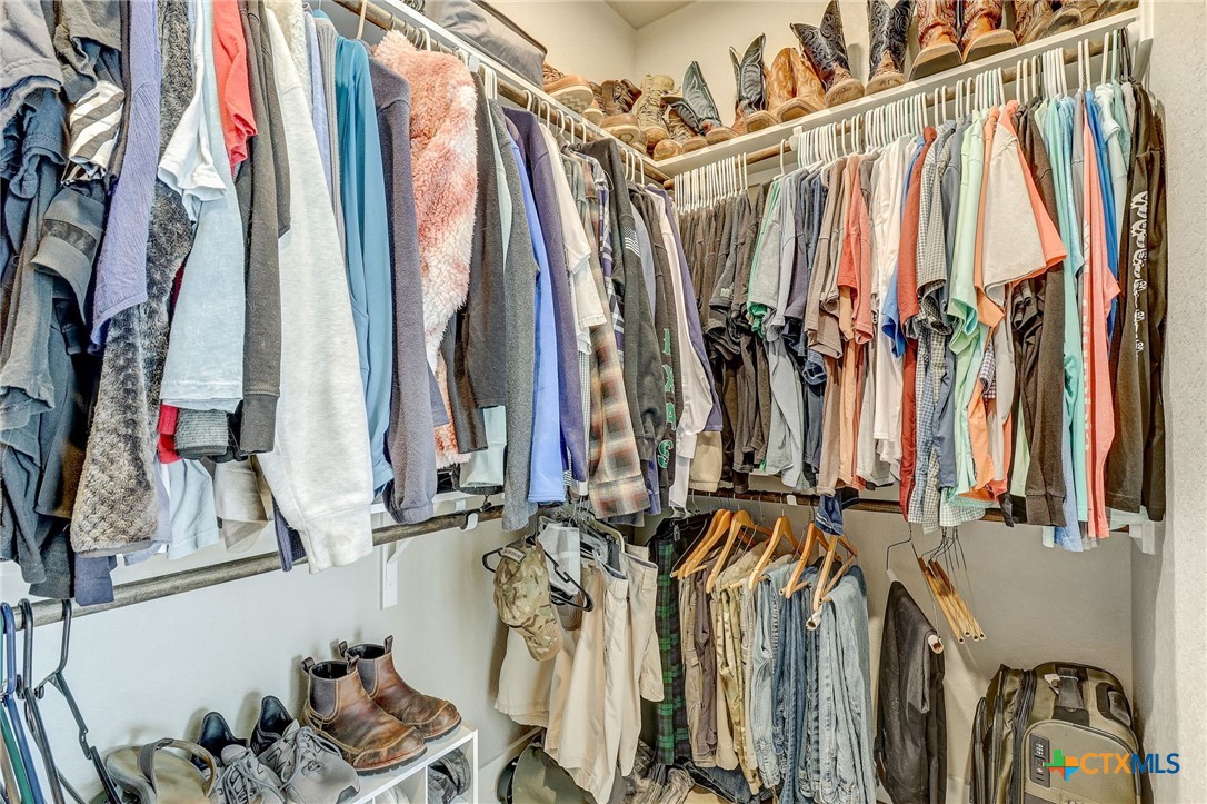281 Cibolo Way La Vernia, TX 78121 - Photo 25 of 47 a view of walk in closet with clothes