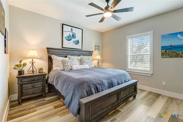 a bedroom with a bed and flat screen tv