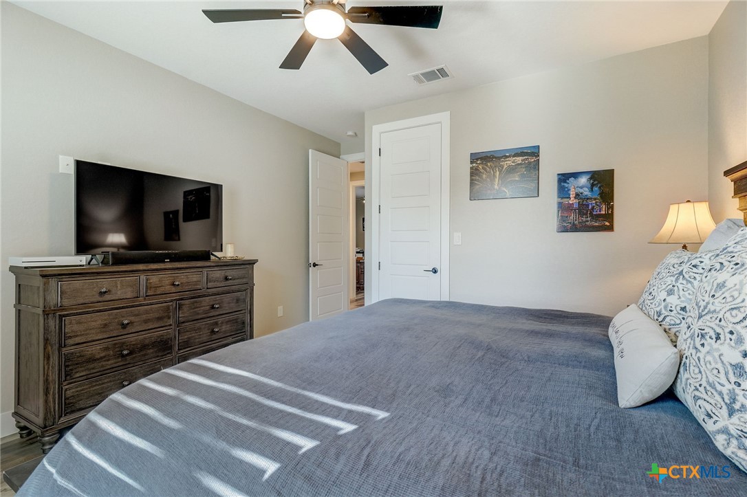281 Cibolo Way La Vernia, TX 78121 - Photo 28 of 47 a bedroom with a bed and flat screen tv