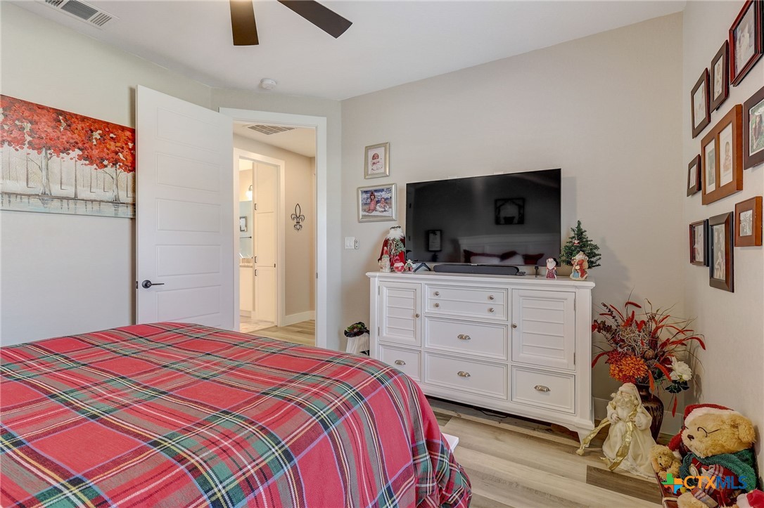 281 Cibolo Way La Vernia, TX 78121 - Photo 33 of 47 a bedroom with a bed and a flat tv screen on dresser