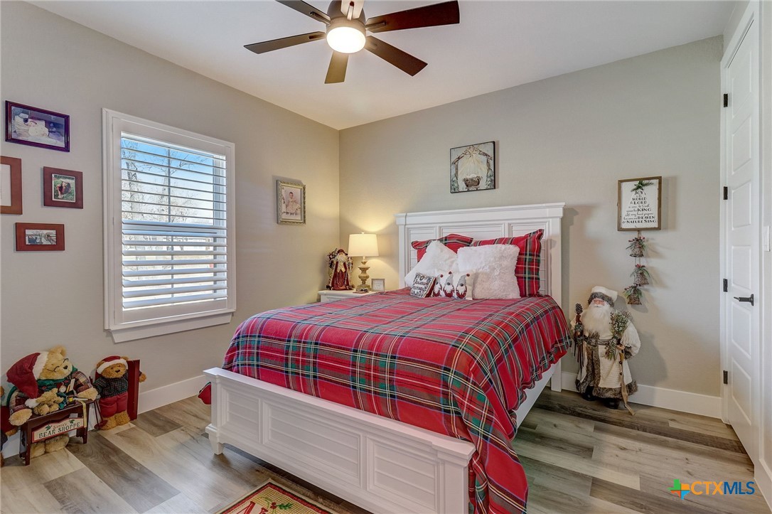 281 Cibolo Way La Vernia, TX 78121 - Photo 34 of 47 a bedroom with a bed and a chandelier