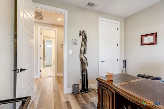 a living room with furniture a fireplace and a large window