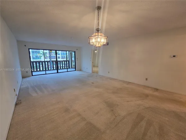 a view of an empty room with a chandelier