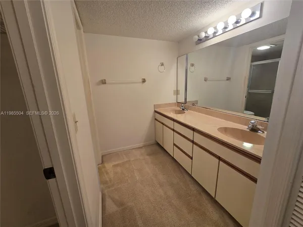 a bathroom with a double vanity sink and a mirror