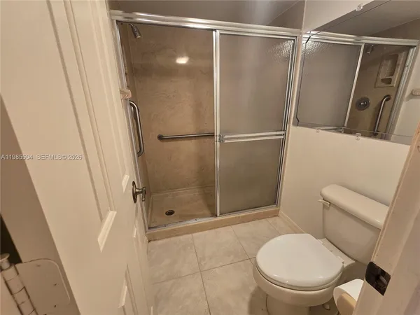 a bathroom with a shower and a toilet
