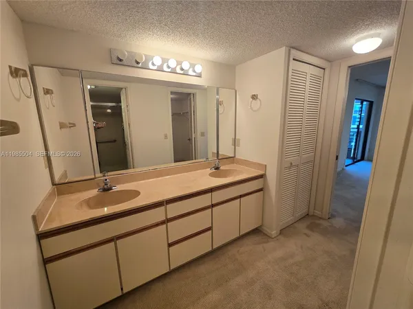 a bathroom with a double vanity sink and a mirror