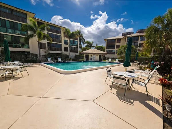 a view of a patio with couches table and chairs and potted plants
