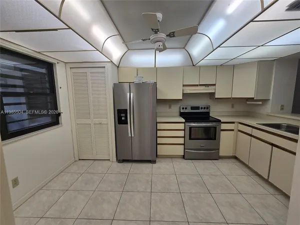 a kitchen with stainless steel appliances a refrigerator and a sink