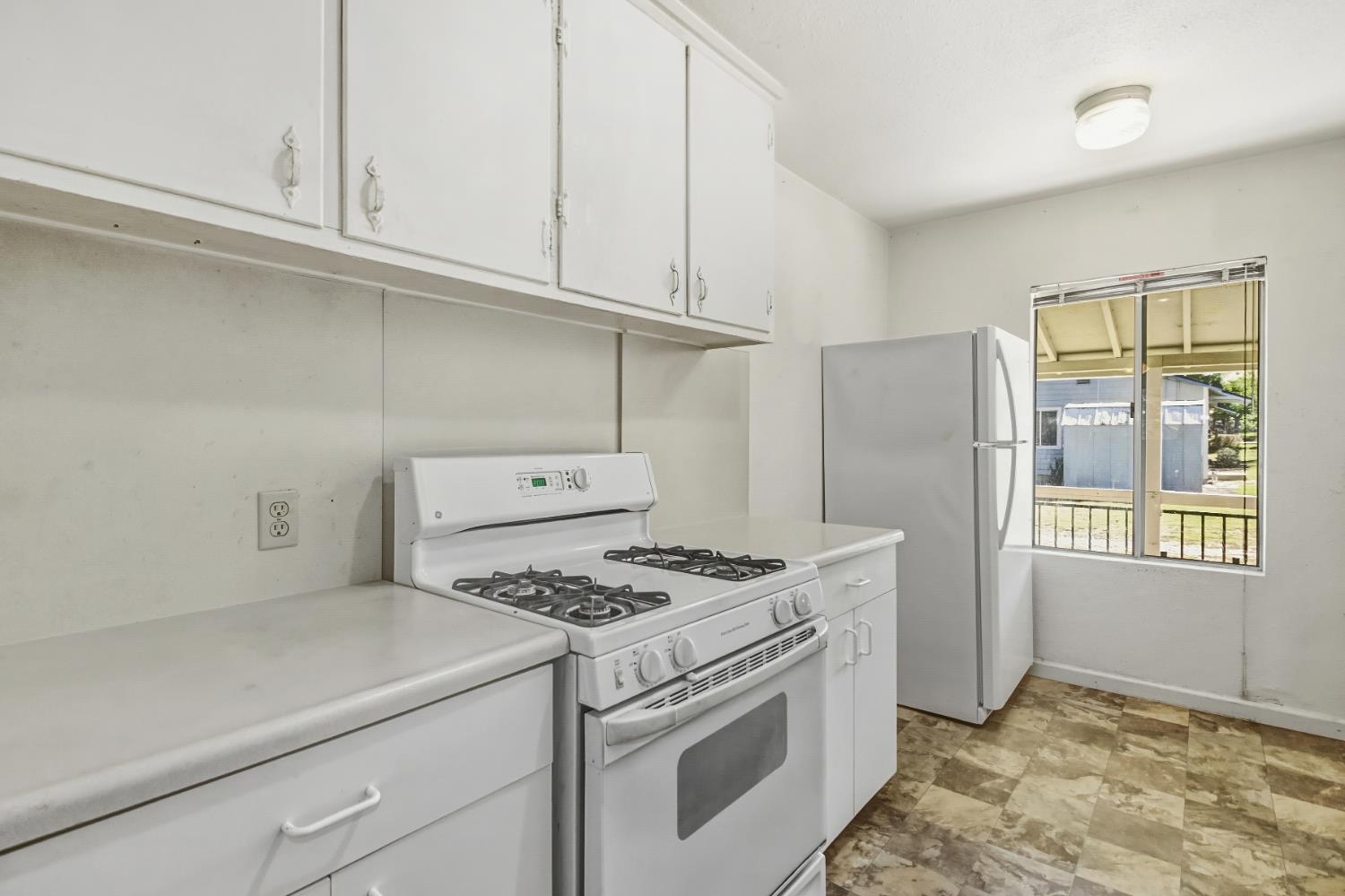3140 Brennans Road Loomis, CA 95650 - Photo 17 of 45 a kitchen with stainless steel appliances granite countertop a stove a refrigerator and a white cabinets