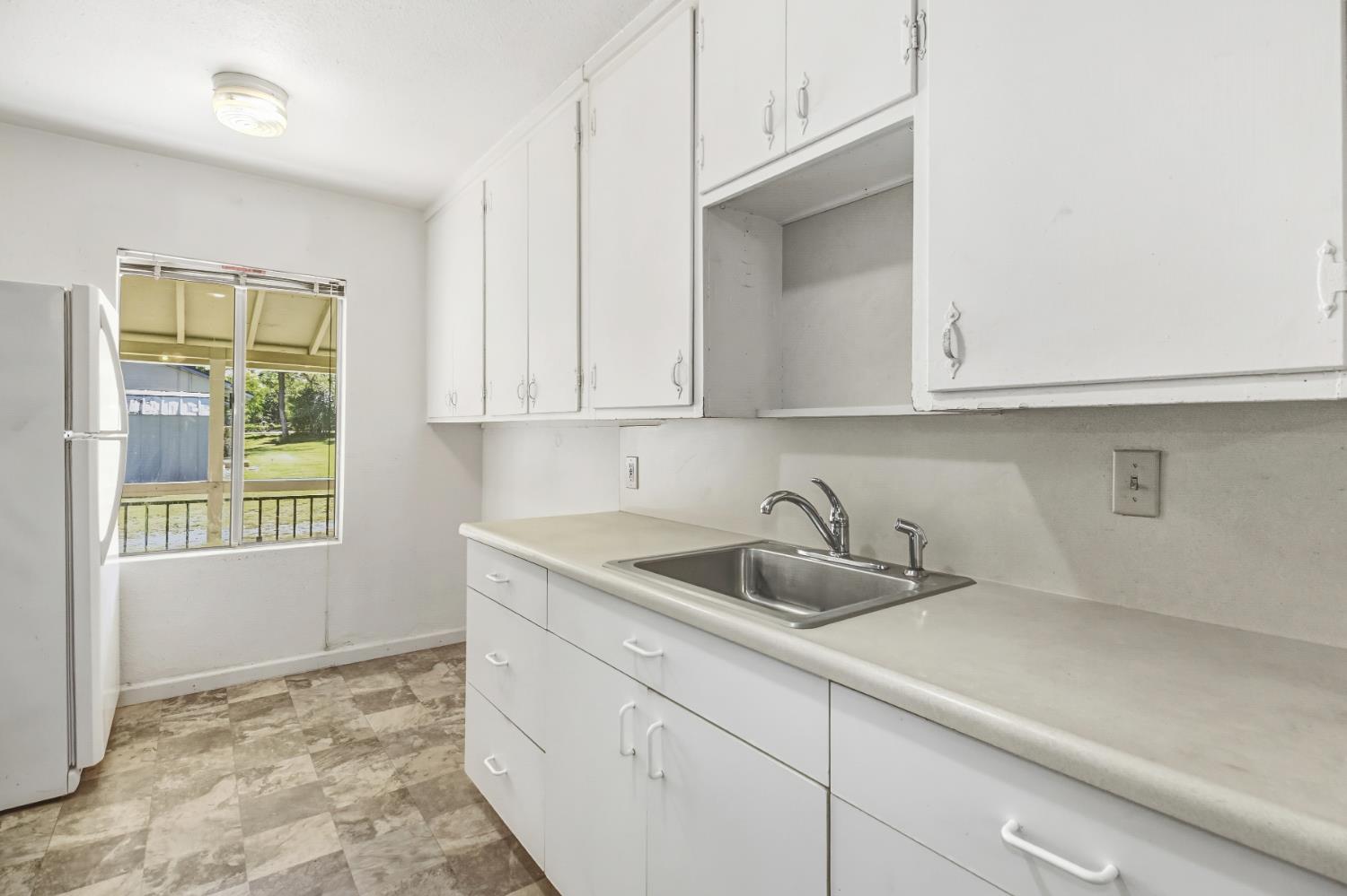 3140 Brennans Road Loomis, CA 95650 - Photo 18 of 45 a kitchen with a sink and cabinets