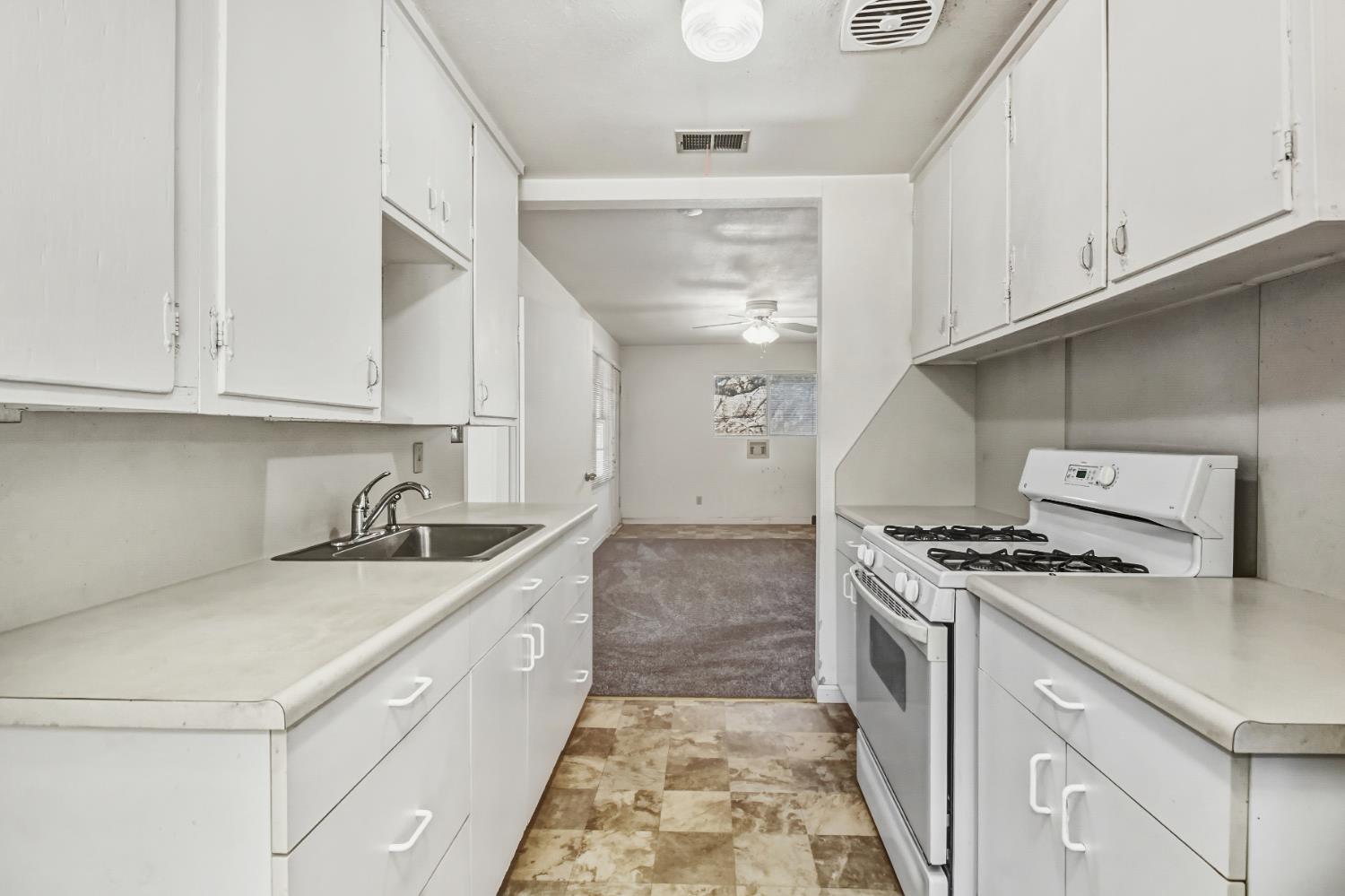 3140 Brennans Road Loomis, CA 95650 - Photo 19 of 45 a kitchen with granite countertop a sink stove and cabinets