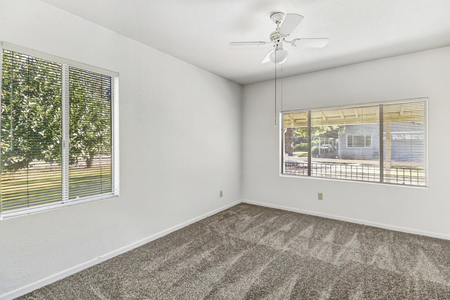 3140 Brennans Road Loomis, CA 95650 - Photo 22 of 45 a view of empty room with windows and chandelier fan