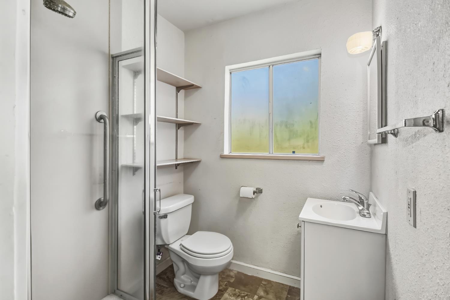 3140 Brennans Road Loomis, CA 95650 - Photo 23 of 45 a bathroom with a toilet sink and shower