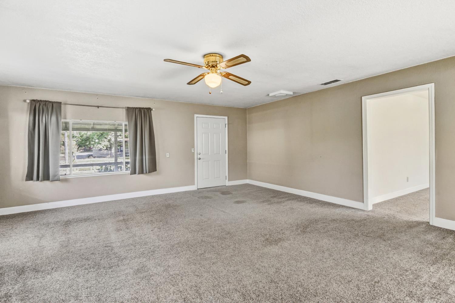 3140 Brennans Road Loomis, CA 95650 - Photo 3 of 45 an empty room with windows and chandelier fan