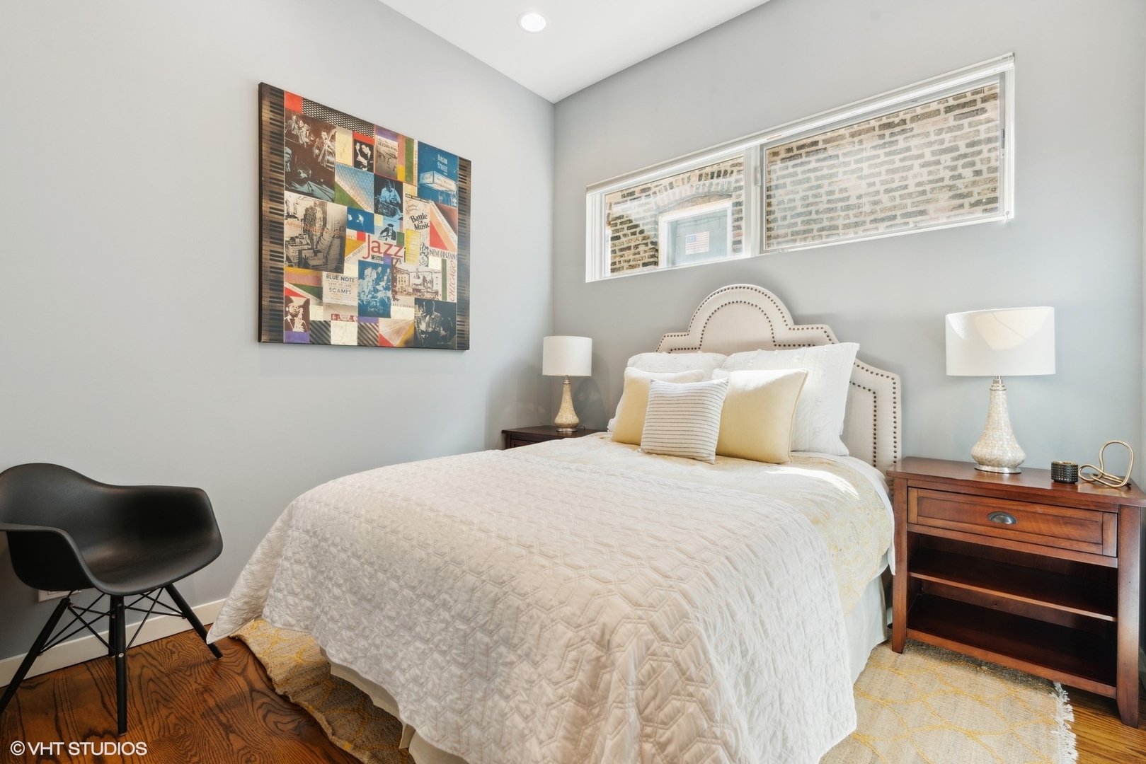 2207 West Chicago Avenue, Unit 3W Chicago, IL 60622 - Photo 8 of 15 a bedroom with a bed and a lamp on dresser