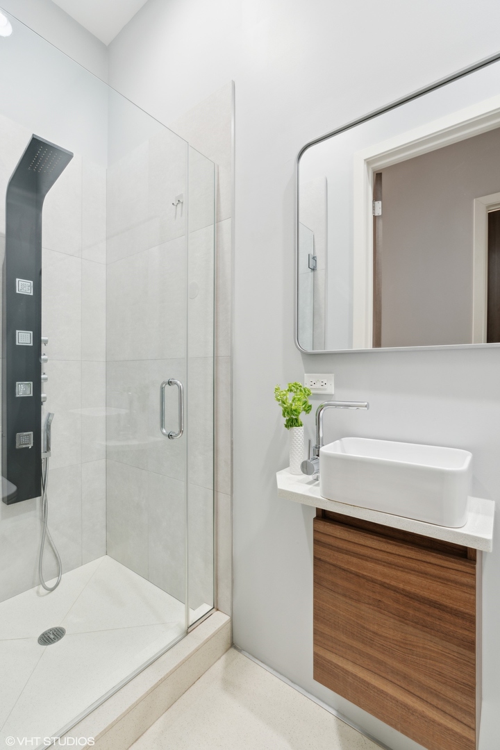 2207 West Chicago Avenue, Unit 3W Chicago, IL 60622 - Photo 10 of 15 a bathroom with a sink and a mirror