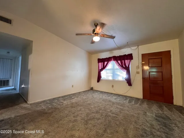 a view of empty room with windows