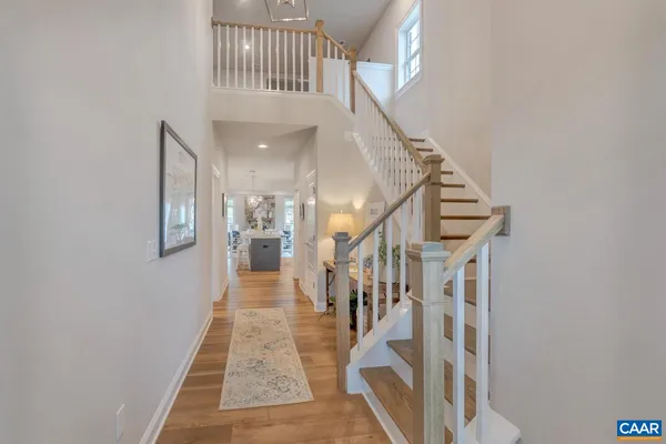 a view of staircase with lots of frames on wall and stairs