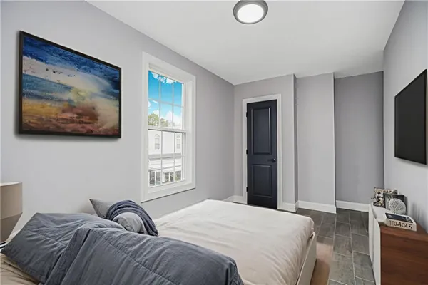 a bedroom with a bed and a flat screen tv