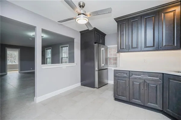 a kitchen with stainless steel appliances granite countertop a refrigerator a sink and dishwasher with wooden floor