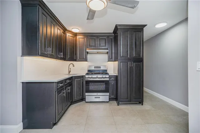 a kitchen with stainless steel appliances granite countertop a stove and a refrigerator