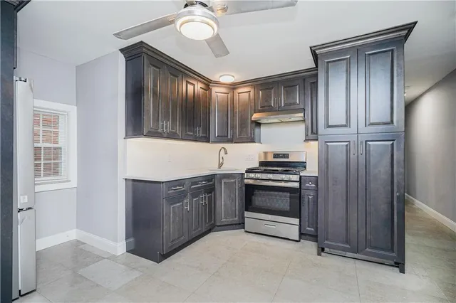 a kitchen with stainless steel appliances granite countertop a stove and a refrigerator