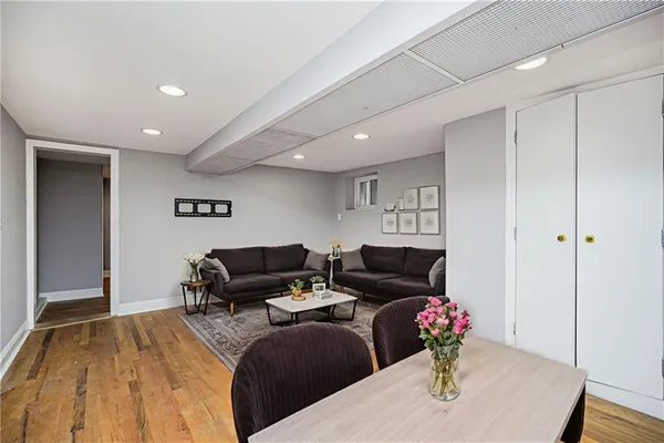 a living room with furniture and wooden floor