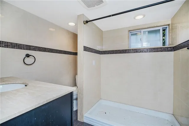 a bathroom with a sink a mirror and a shower